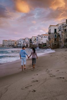 Cefalu, the medieval village of Sicily island, Province of Palermo, Italy. Europe, a couple on vacation at the Italian Island Sicilia