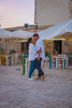 The picturesque village of Marzamemi, in the province of Syracuse, Sicily Italy, a couple on vacation in Sicilia