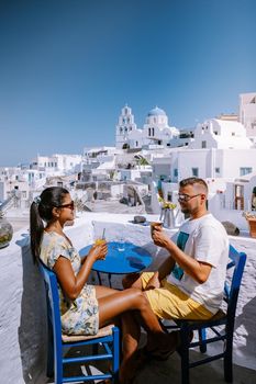 Pyrgos, Santorini, Greece. Famous attraction of white village with cobbled streets, Greek Cyclades Islands, Aegean Sea couple on vacation Santorini Greece Europe