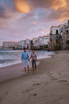 Cefalu, the medieval village of Sicily island, Province of Palermo, Italy. Europe, a couple on vacation at the Italian Island Sicilia