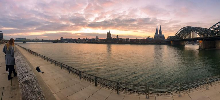 Cologne Germany alongside the rhein river during sunset with the huge Cathedral in Koln