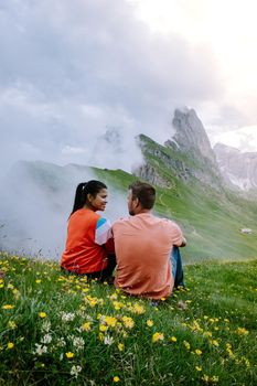 couple on vacation hiking in the Italien Dolomites, Amazing view on Seceda peak. Trentino Alto Adige, Dolomites Alps, South Tyrol, Italy, Europe. Seceda Peak