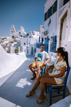 Pyrgos, Santorini, Greece. Famous attraction of white village with cobbled streets, Greek Cyclades Islands, Aegean Sea couple on vacation Santorini Greece Europe