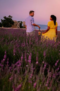 Provence, Lavender field France, Valensole Plateau, colorful field of Lavender Valensole Plateau, Provence, Southern France. Lavender field. Europe. Couple men and woman on vacation at the provence lavender fields,