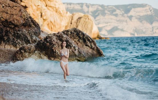 Woman near rocky mountains island sea travel fresh air. High quality photo