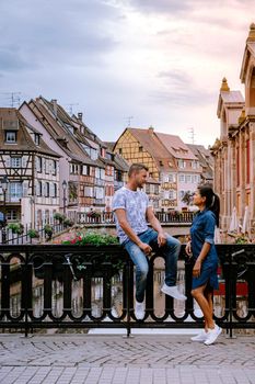 couple on city trip Colmar, Alsace, France. Petite Venice, water canal and traditional half timbered houses. Colmar is a charming town in Alsace, France. Beautiful view of colorful romantic city Colmar