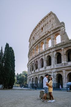 View of Colosseum in Rome and morning sun, Italy, Europe. Couple on city trip in Rome