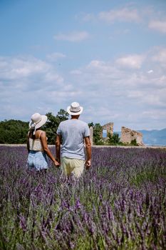 Provence, Lavender field France, Valensole Plateau, colorful field of Lavender Valensole Plateau, Provence, Southern France. Lavender field. Europe. Couple men and woman on vacation at the provence lavender fields,