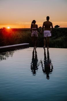 Luxury resort with a view over the wine field in Selinunte Sicily Italy. infinity pool with a view over wine fields in Sicilia, a couple on luxury vacation at the Island of Sicily Italy