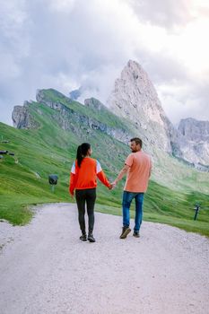 couple on vacation hiking in the Italien Dolomites, Amazing view on Seceda peak. Trentino Alto Adige, Dolomites Alps, South Tyrol, Italy, Europe. Seceda Peak