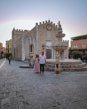 Taormina Sicily, Belvedere of Taormina and San Giuseppe church on the square Piazza IX Aprile in Taormina. Sicily, Italy. Couple on vacation at the Italian Island Sicily