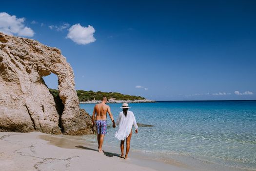 Tropical beach of Voulisma beach, Istron, Crete, Greece ,Most beautiful beaches of Crete island -Istron bay near Agios Nikolaos young couple mid age on vacation in Greece Crete