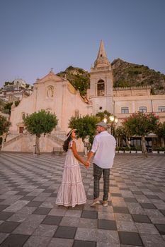 Taormina Sicily, Belvedere of Taormina and San Giuseppe church on the square Piazza IX Aprile in Taormina. Sicily, Italy. Couple on vacation at the Italian Island Sicily