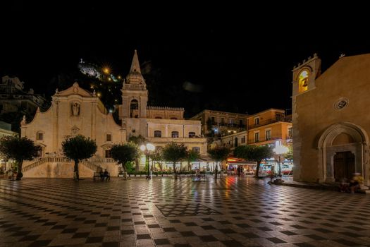 Taormina Sicily during sunset in the old town with narrow streets and lights. Sicily