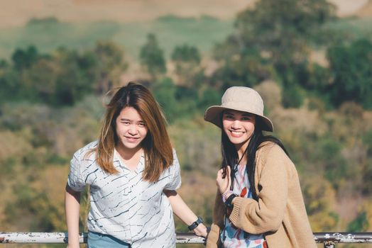 Asian pretty cute women with hat relax at seaside city landscape viewpoint on mountain with happy and freedom emotion in concept travel, vacation, leisure in life