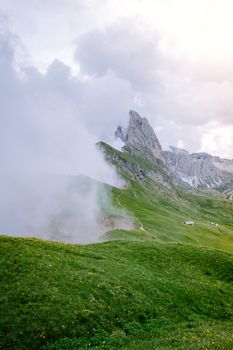  hiking in the Italien Dolomites, Amazing view on Seceda peak. Trentino Alto Adige, Dolomites Alps, South Tyrol, Italy, Europe. Odle mountain range, Val Gardena. Majestic Furchetta peak in morning sunlight. Italy