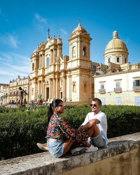 Sicily Italy, view of Noto old town and Noto Cathedral, Sicily, Italy. beautiful and typical streets and stairs in the baroque town of Noto in the province of Syracuse in Sicily, a couple on city trip Noto