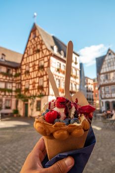 Mainz Germany hand with ice cream, Classical timber houses in the center of Mainz, Germany Europe