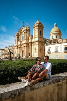 Sicily Italy, view of Noto old town and Noto Cathedral, Sicily, Italy. beautiful and typical streets and stairs in the baroque town of Noto in the province of Syracuse in Sicily, a couple on city trip Noto