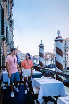 couple men and woman on a city trip to Venice Italy, colorful streets with canals Venice. Europe