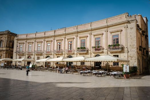 Ortigia in Syracuse Sicily Italy October 2020 in the Morning. Travel Photography from Syracuse, Italy on the island of Sicily. Cathedral Plaza and market with people wearing face protection during the 2020 pandemic covid 19 corona virus