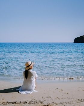 Tropical beach of Voulisma beach, Istron, Crete, Greece ,Most beautiful beaches of Crete island -Istron bay near Agios Nikolaos young asian woman mid age on vacation Greece Crete