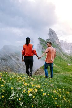 couple on vacation hiking in the Italien Dolomites, Amazing view on Seceda peak. Trentino Alto Adige, Dolomites Alps, South Tyrol, Italy, Europe. Seceda Peak