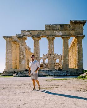 A guy visit Greek temples at Selinunte during vacation, View on sea and ruins of greek columns in Selinunte Archaeological Park Sicily Italy