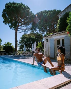 couple relaxing by the pool in the Provence France, men and woman relaxing by pool at luxury resort France