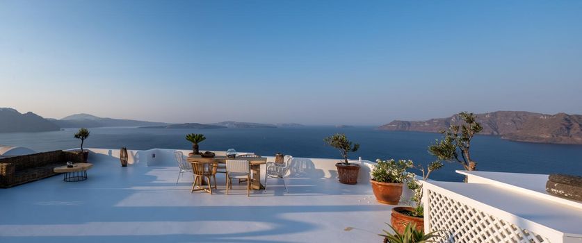 Sunset at the Island Of Santorini Greece, beautiful whitewashed village Oia with church and windmill during sunset, streets of Oia Santorini during summer vacation at the Greek Island