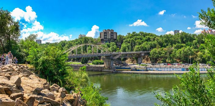 Dnipro, Ukraine 07.18.2020. Pedestrian bridge to the monastery island across the Dnieper river in Dnipro, Ukraine, on a sunny summer day