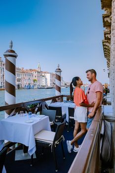 couple men and woman on a city trip to Venice Italy, colorful streets with canals Venice. Europe