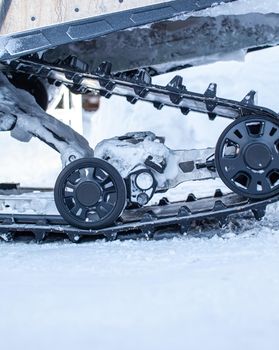 The back of the snowmobile in winter. Snowmobile under repair. Riding in the snow