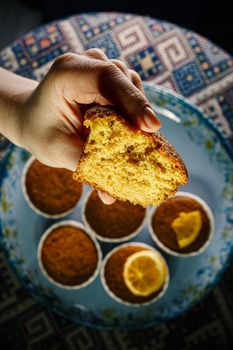 Fresh muffin in a woman's hand. Close-up texture of the dough