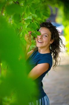 Portrait of young beautiful brunette enjoy walking in green summer park.