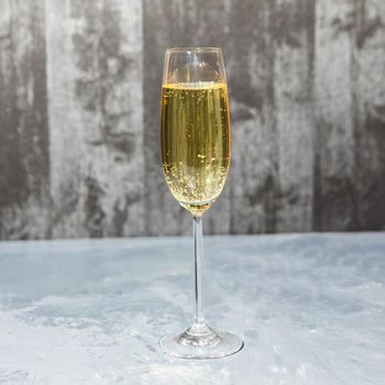 Glass of champagne isolated on a gray background