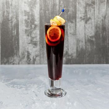 Glass of lemon cocktail isolated on a gray background