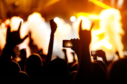 Crowd at a concert. Hands and smartphones in front of the stage