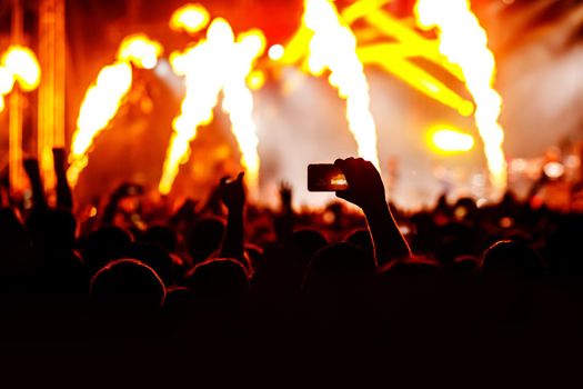 Crowd at a concert. Hands and smartphones in front of the stage