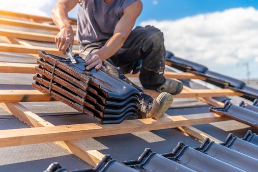 manufacture of the roof of a family house from ceramic tiles. copy space