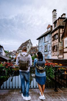 couple on city trip Colmar, Alsace, France. Petite Venice, water canal and traditional half timbered houses. Colmar is a charming town in Alsace, France. Beautiful view of colorful romantic city Colmar