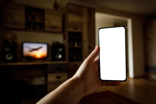 Mockup of using a smartphone in the home interior. Blank white screen for your idea