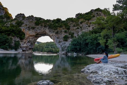 woman on the beach by the river in the Ardeche France Pont d Arc, Ardeche France,view of Narural arch in Vallon Pont D'arc in Ardeche canyon in France Europe