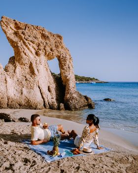 Tropical beach of Voulisma beach, Istron, Crete, Greece ,Most beautiful beaches of Crete island -Istron bay near Agios Nikolaos young couple mid age on vacation in Greece Crete