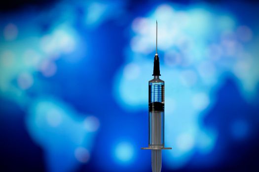 Syringe with vaccine on blue background