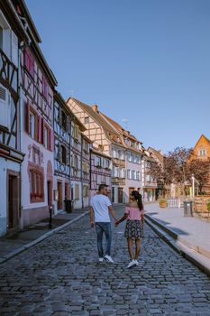 couple on city trip Colmar, Alsace, France. Petite Venice, water canal and traditional half timbered houses. Colmar is a charming town in Alsace, France. Beautiful view of colorful romantic city Colmar