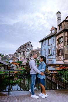 couple on city trip Colmar, Alsace, France. Petite Venice, water canal and traditional half timbered houses. Colmar is a charming town in Alsace, France. Beautiful view of colorful romantic city Colmar