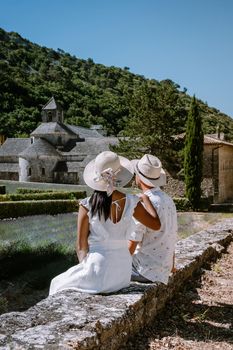 couple visit the old town of Gordes Provence,Blooming purple lavender fields at Senanque monastery, Provence, southern France. Europe