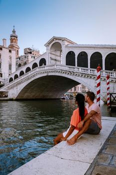 couple men and woman on a city trip to Venice Italy, colorful streets with canals Venice. Europe