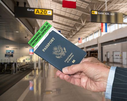 Mockup of airport terminal with businessman hand holding passport and Vaccination certificate to coronavirus